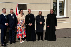 Członkowie wydarzenia stojący przed nowo odsłoniętą tablicą. Wśród zgromadzonych są, między innymi, Profesor Sabina Bober, Ksiądz Biskup Mieczysław Cisło, Rabin Symcha Keller oraz Burmistrz Karol Ługowski.