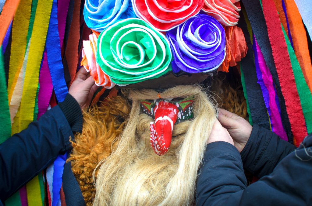 Brodacze, przebierańcy, siła tradycji w Sławatyczach, postaci przebrani w długie płaszcze, kolorowe kapelusze z bibuły, dugie brody.
